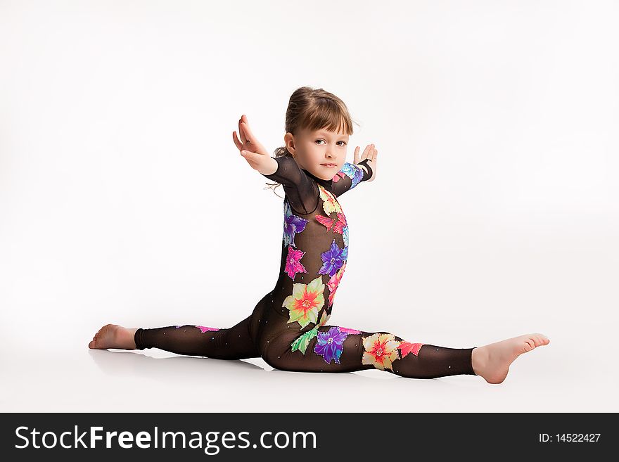 Little girl in gym clothing making exercises. Little girl in gym clothing making exercises