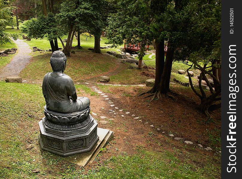 Wide angle view of a buddha statue in a park