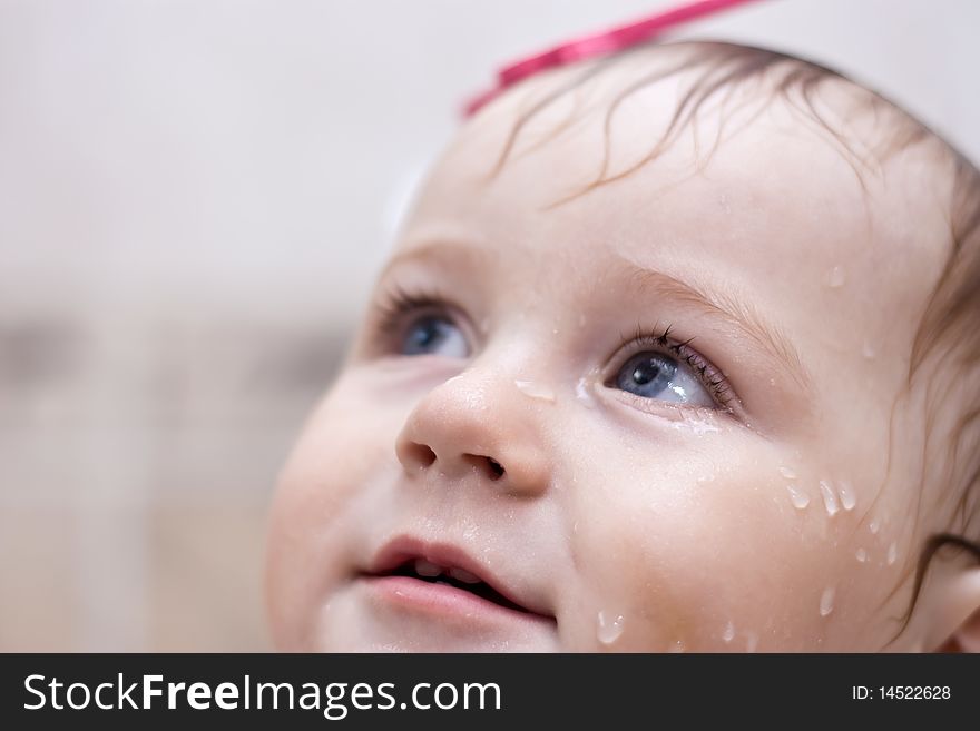 Portrait of wet baby in bath