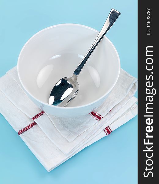 Plates and cutlery isolated against a blue background