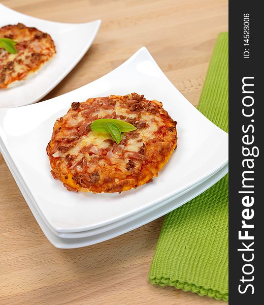 Mini Pizzas isolated on a kitchen bench