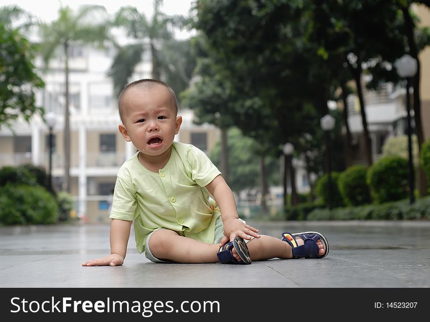 It is a cute Chinese baby, he is crying in the outdoor. It is a cute Chinese baby, he is crying in the outdoor.