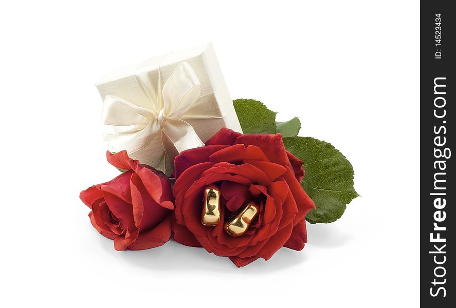 Earrings box and red rose on white background. Earrings box and red rose on white background