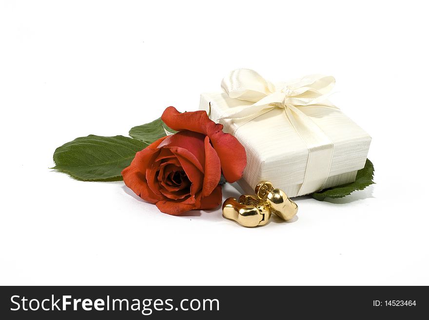 Earrings box and red rose on white background. Earrings box and red rose on white background