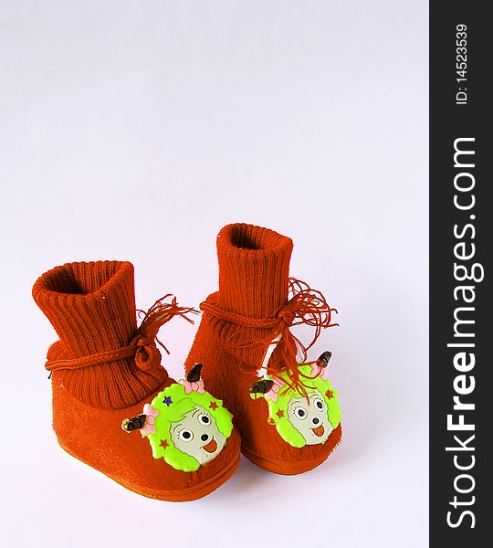 Red baby shoes isolated on white background