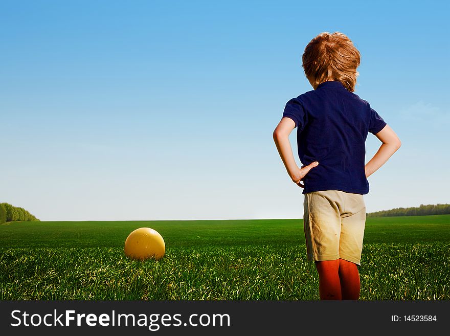 Small boy with yellow ball in field. Small boy with yellow ball in field