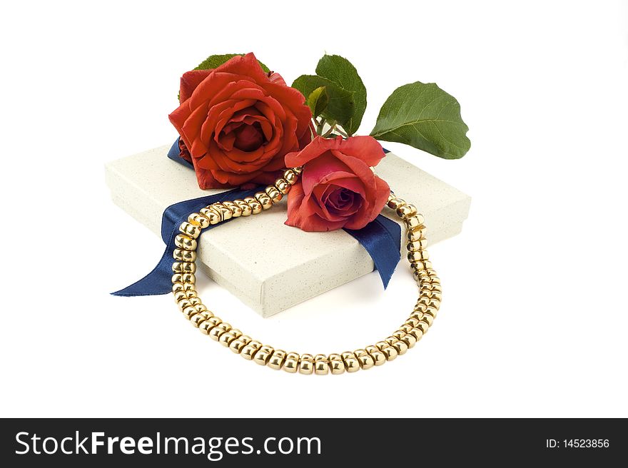 Necklace and red rose on white background. Necklace and red rose on white background
