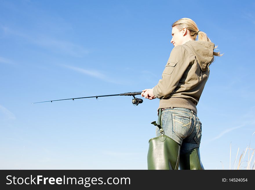 Fishing woman with fishing rod