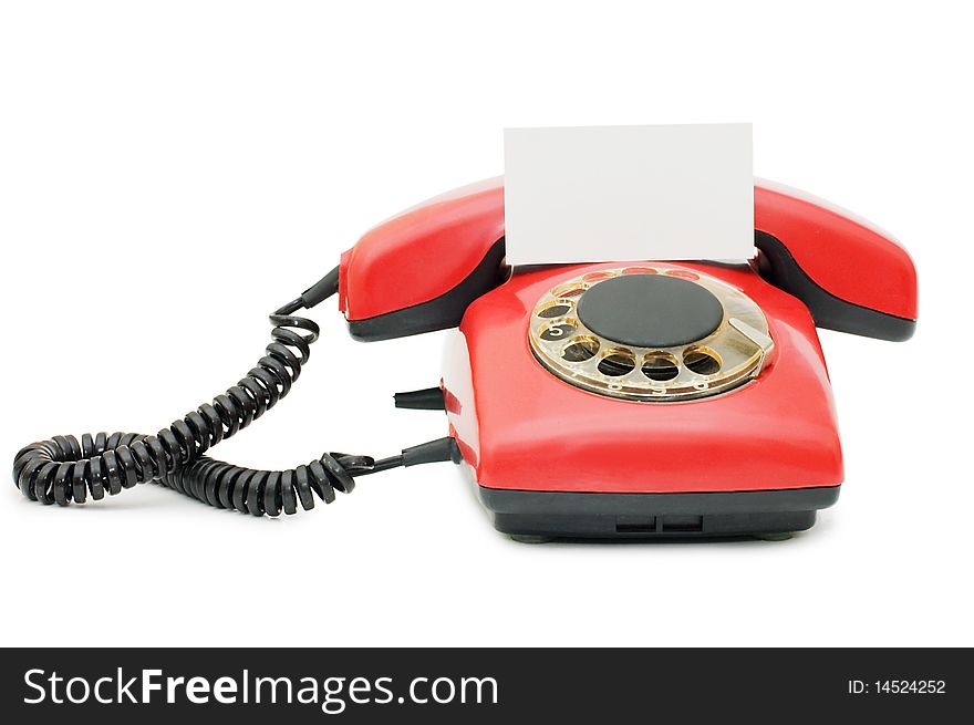 Red old telephone isolated on white