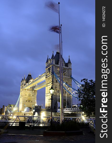 Tower Bridge at night with blue sky in background