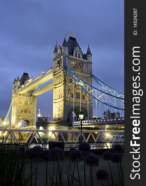 Tower Bridge at night with blue sky in background