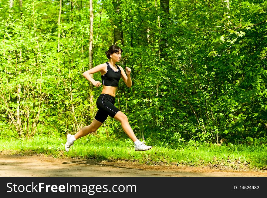 Young woman running in park. Young woman running in park