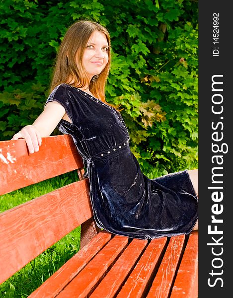Young smiling woman resting on bench. Young smiling woman resting on bench