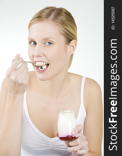 Portrait of woman eating yogurt. Portrait of woman eating yogurt