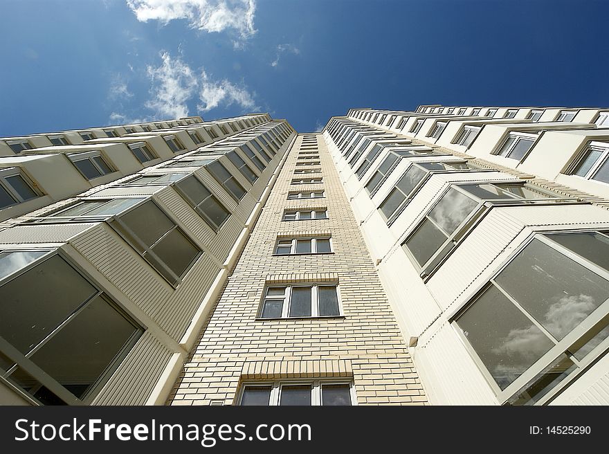 Moscow, Russia, the new multi-storey residential building on a background of blue sky. Moscow, Russia, the new multi-storey residential building on a background of blue sky