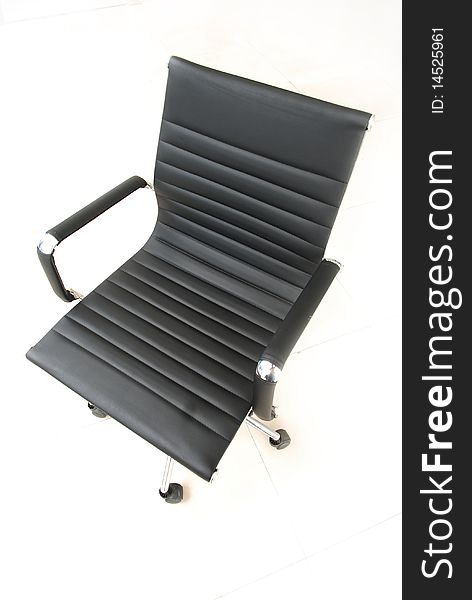 Isolated black leather and steel chair.
