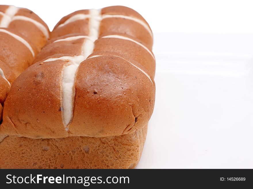 Hot cross buns on the left side against a white background