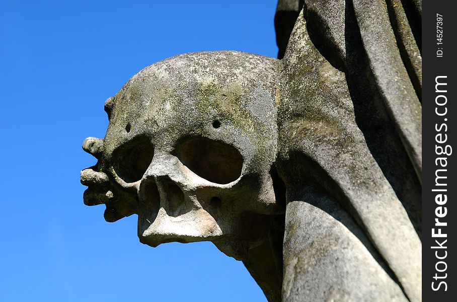 Skull with hand (part of a stone sculpture)