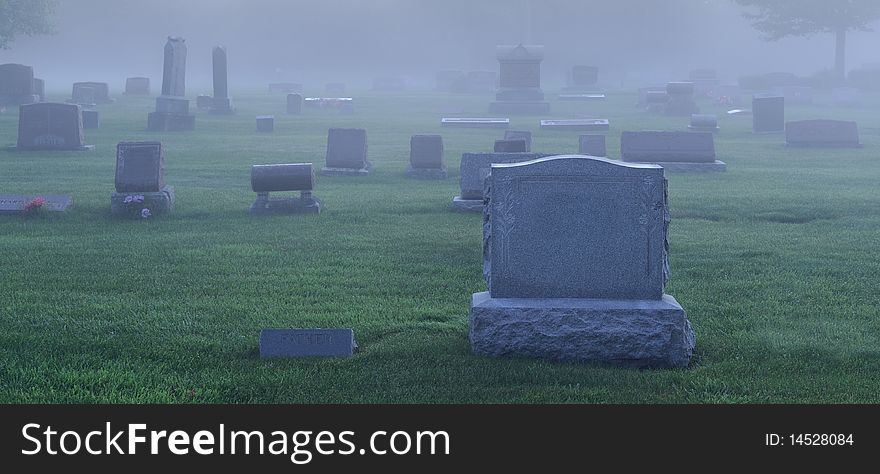 Fog settles in over an old cemetery. Fog settles in over an old cemetery