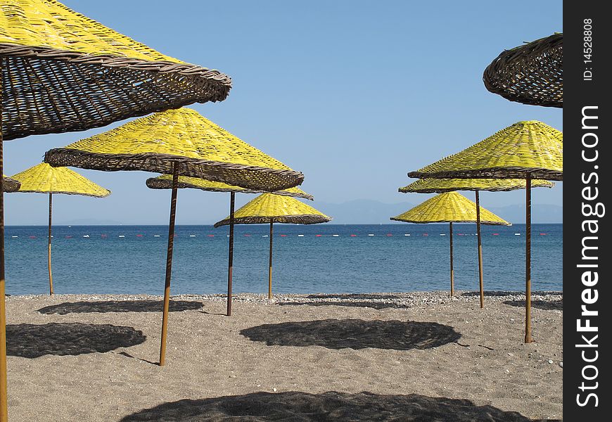 Yellow parasols at the beach of Mediterranean sea