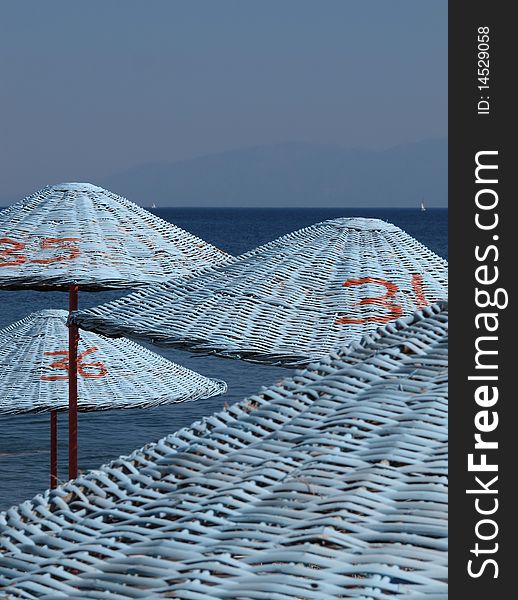 Blue parasols at the beach of Mediterranean sea