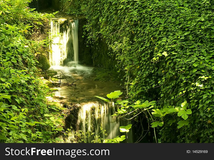 Cascade drop forest grass nature reflection river summer sunlight water waterfall. Cascade drop forest grass nature reflection river summer sunlight water waterfall