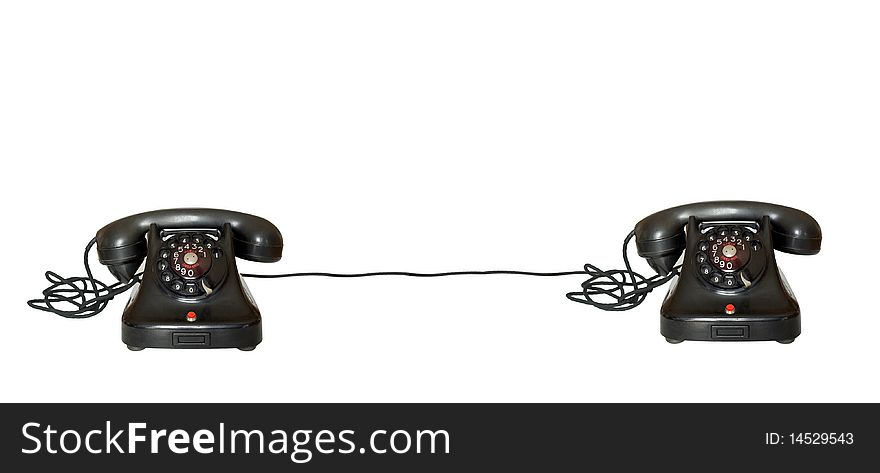 Two telephones joint on white background with cable
