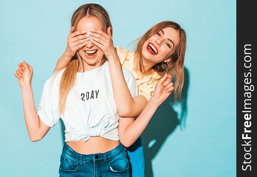 Two young beautiful hipster girls in trendy clothes in studio