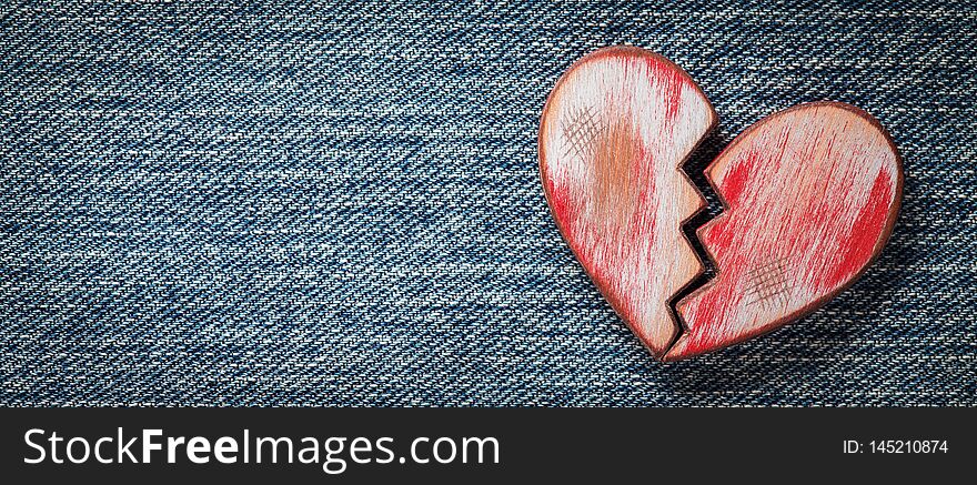 Rustic red broken heart on jeans. Valentines Day. Rustic red broken heart on jeans. Valentines Day