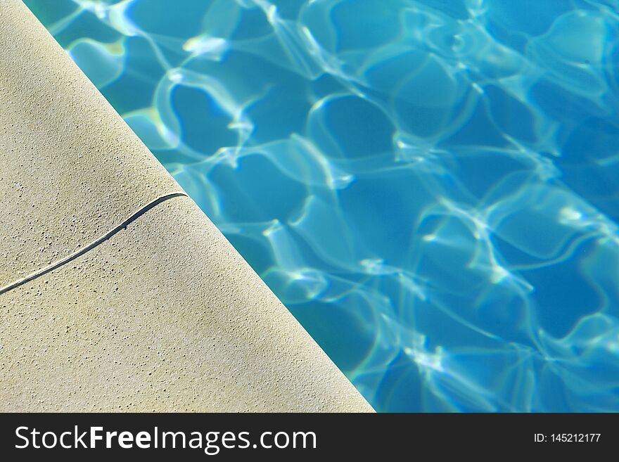 Close up of a swimming pool in Summer, edge, holidays, bath, water, relaxing, blue, architecture, stoned, detail, macro, macrophotography, leisure, transparency, reflection