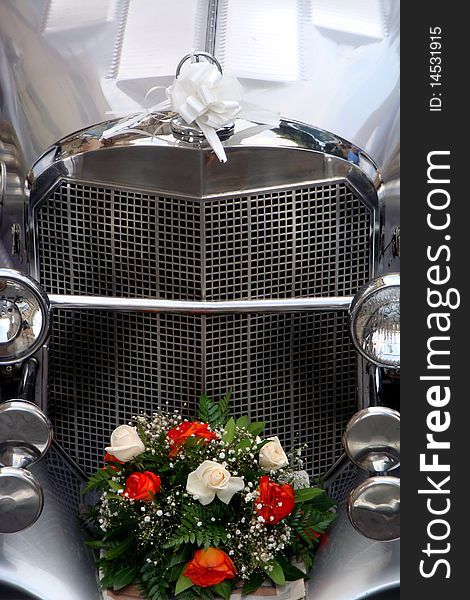 Just married car with flowers and white ribbon