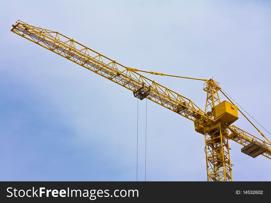 Crane over blue sky with clouds