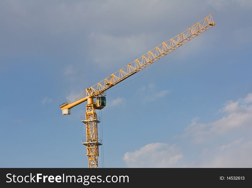 Crane over blue sky with clouds