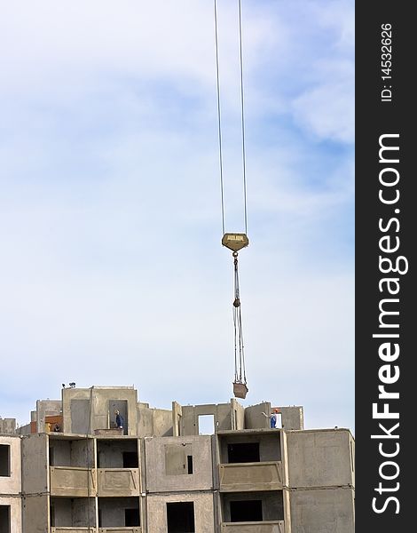 Crane over blue sky with building. Crane over blue sky with building