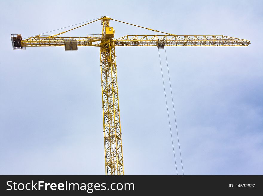 Crane over blue sky with clouds