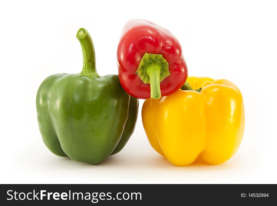 Three whole Red, Green and Yellow bell peppers isolated on a white background. Three whole Red, Green and Yellow bell peppers isolated on a white background