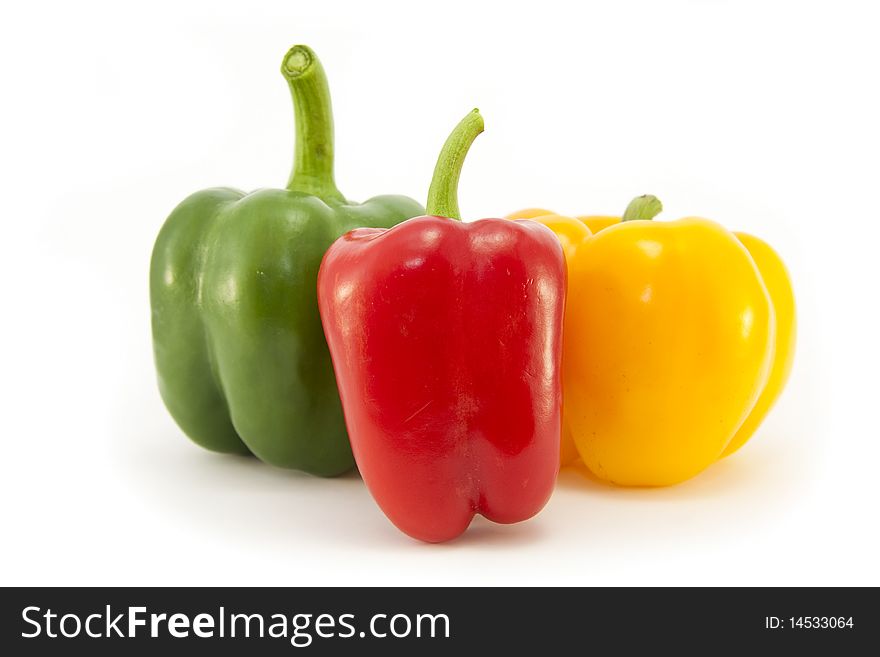 Whole Red, Green and Yellow Bell peppers isolated on a white background. Whole Red, Green and Yellow Bell peppers isolated on a white background