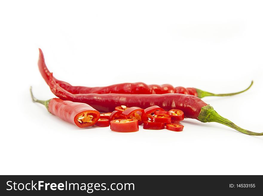 Sliced fresh red chillies isolated on a white background. Sliced fresh red chillies isolated on a white background