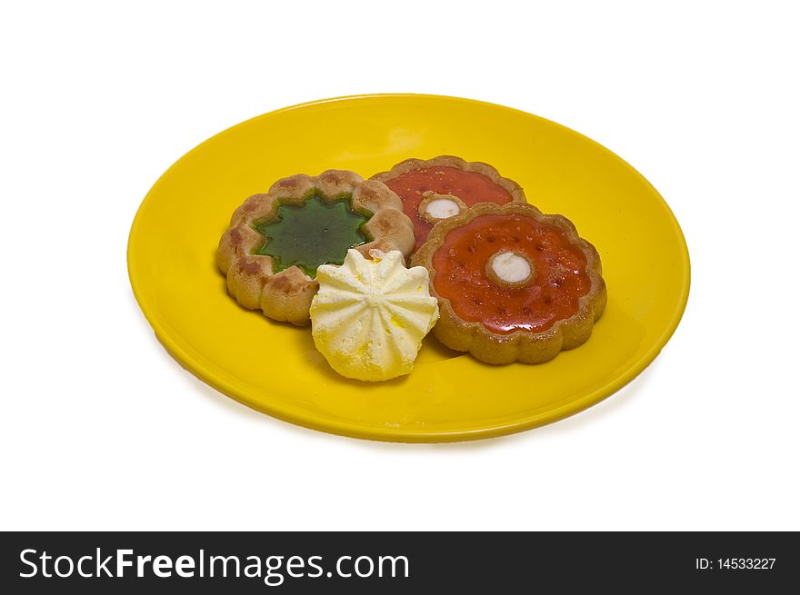 Some cakes on a plate with color jam is a sweet dessert. Some cakes on a plate with color jam is a sweet dessert