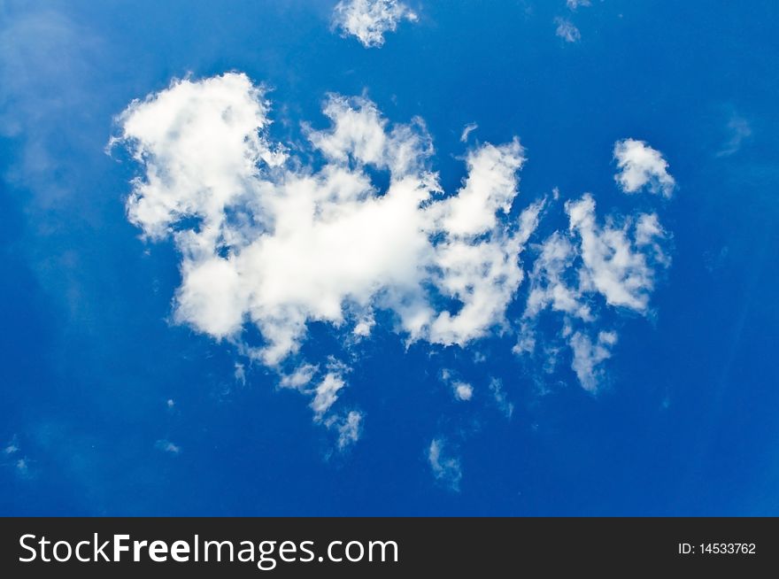 A deep blue sky with fluffy white clouds