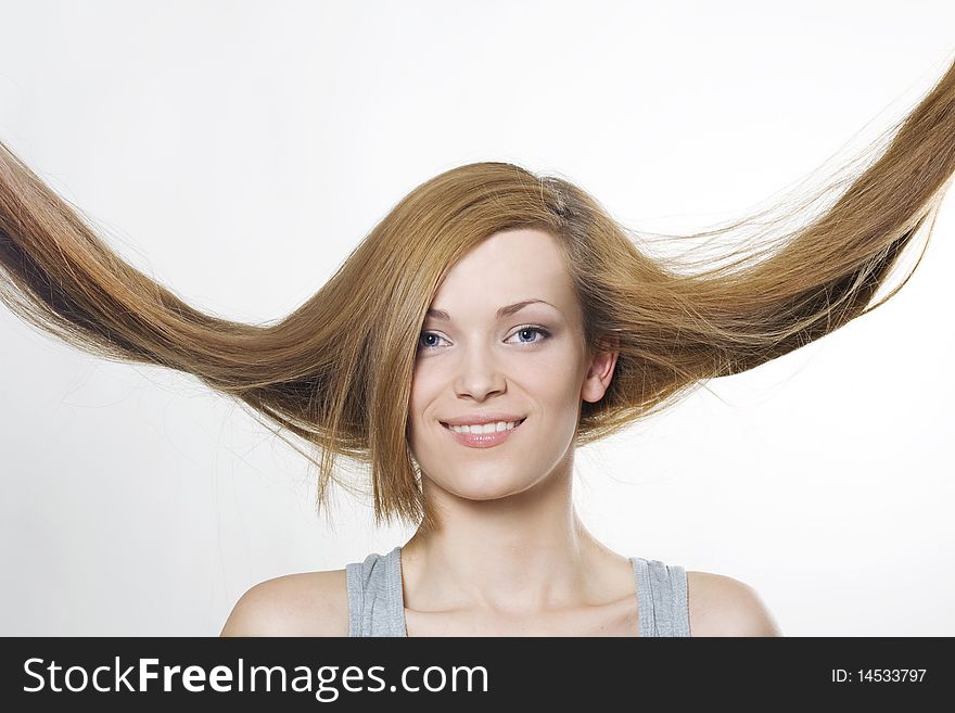 Young woman with hair flying over white. Young woman with hair flying over white