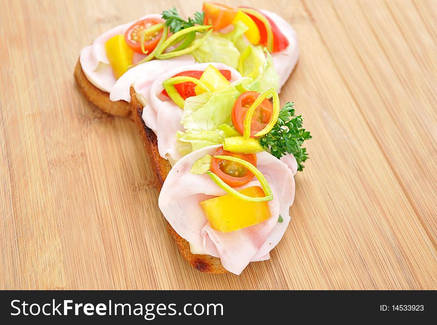 Toaste, canape, bruschette, with tomato, vegetable and ham. Toaste, canape, bruschette, with tomato, vegetable and ham