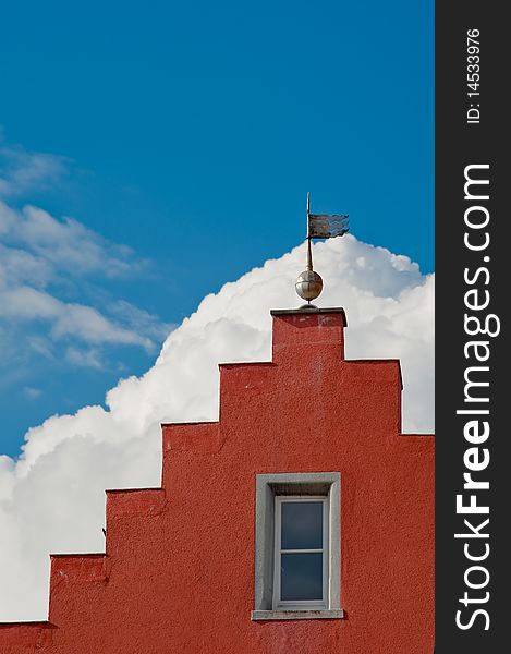 Red gable in front of blue sky