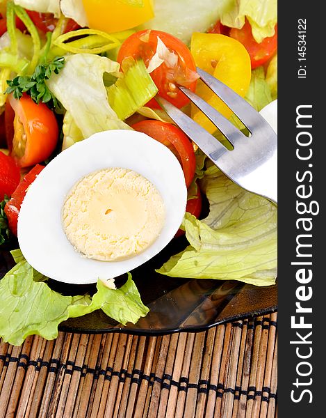 Fresh vegetable salad with eggs and fork. Fresh vegetable salad with eggs and fork