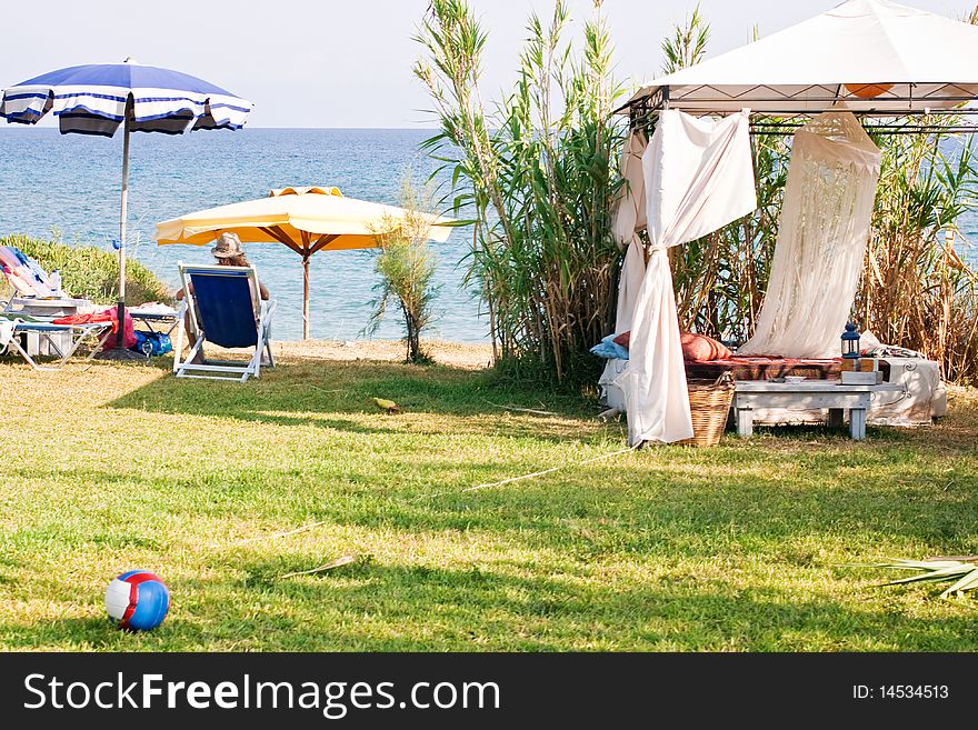 Gazebo and umbrellas on the grass overlooking the sea. Gazebo and umbrellas on the grass overlooking the sea