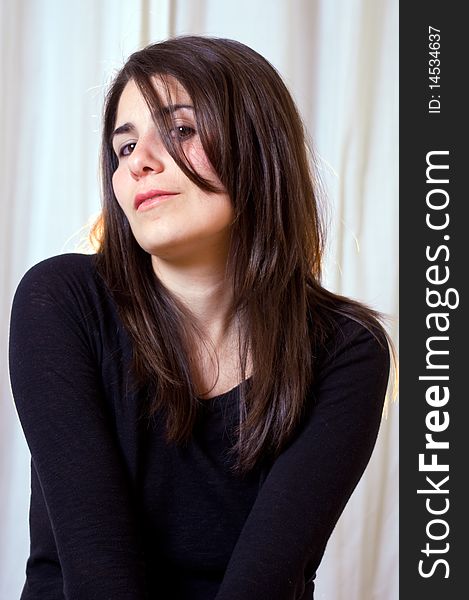 Photo of a young woman posing for a portrait photograph. Photo of a young woman posing for a portrait photograph