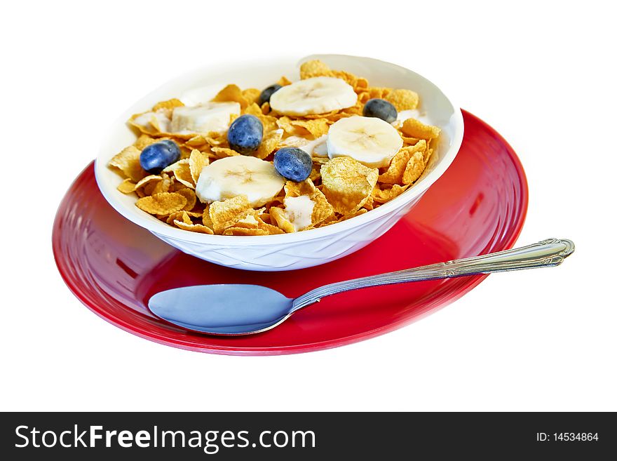 Bowl of corn flakes with bananas and blueberries