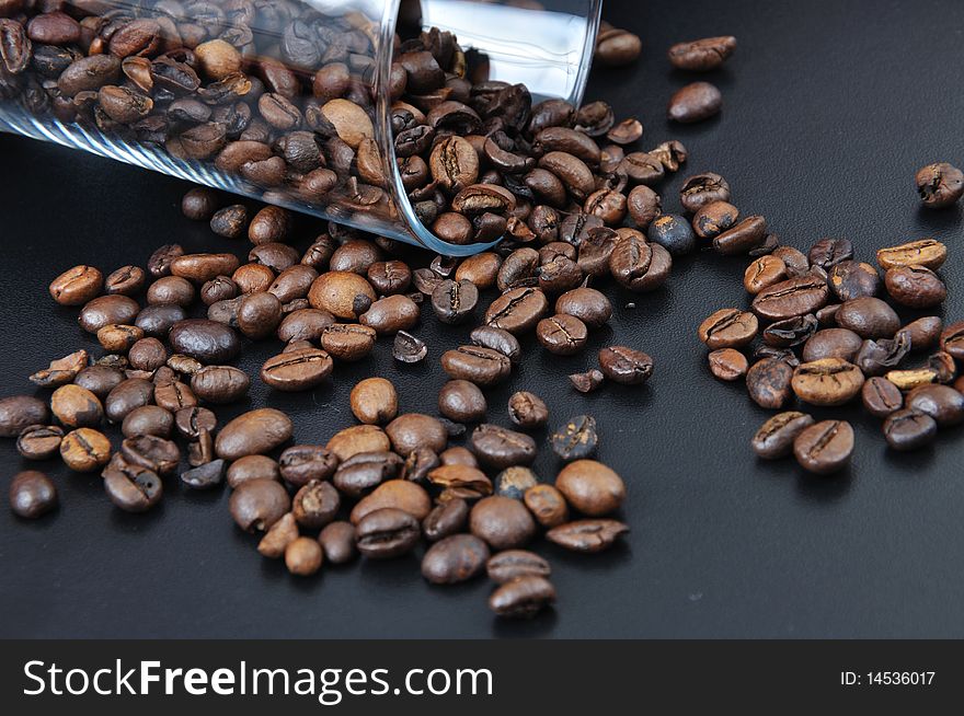 Pure glass with coffee granules on black table