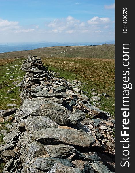 A stone wall forming an ancient road