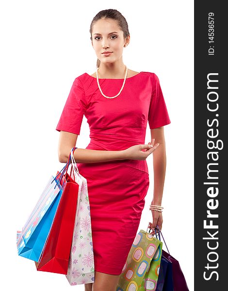Young beautiful woman in red dress with color packages. Young beautiful woman in red dress with color packages